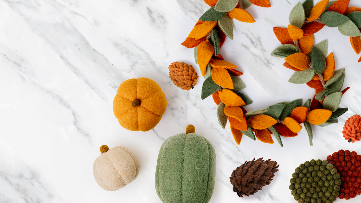 Harvest spread featuring felt gourds, pumpkins and autumnal colored garland