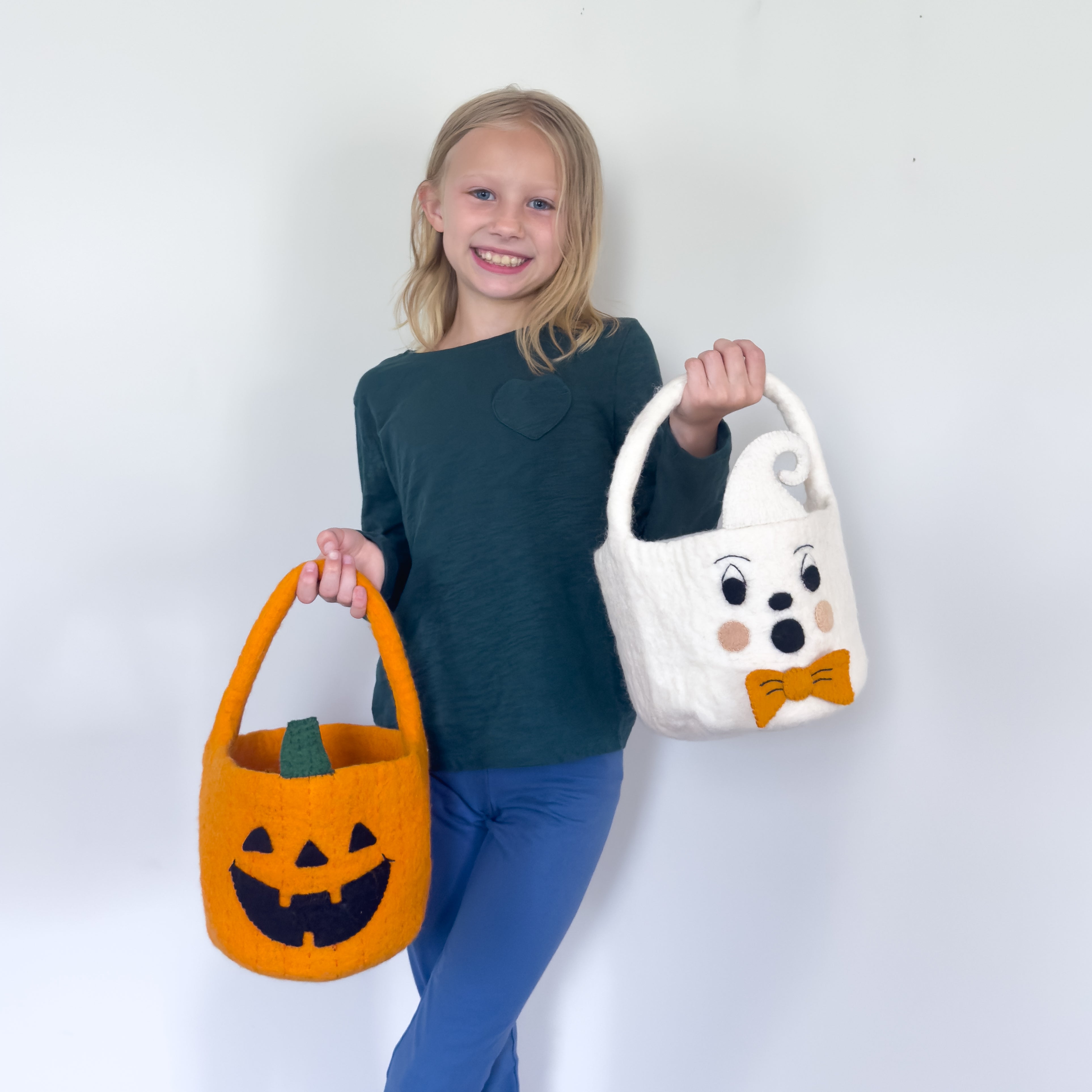 child holding trick or treat felt buckets