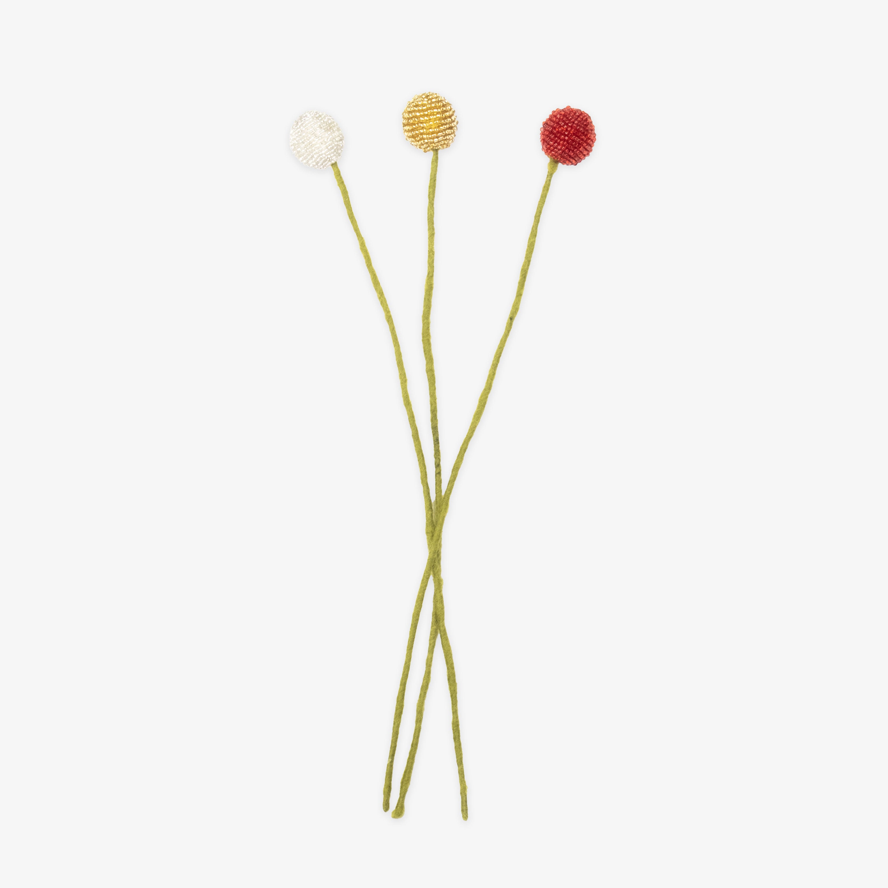 Three craspedia flowers with colorful tops on a white background, all handmade by women artisans | Global Goods Partners