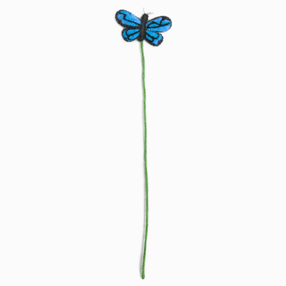 Blue felt butterfly on a green stem against a white background, made by women artisans in Nepal | Global Goods Partners