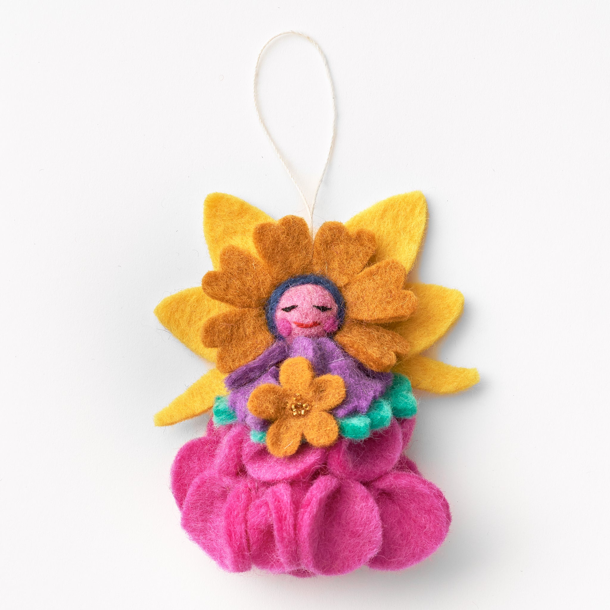 Felt flower-shaped ornament with a small figure inside on a white background. made by women artisans in Nepal | Global Goods Partners