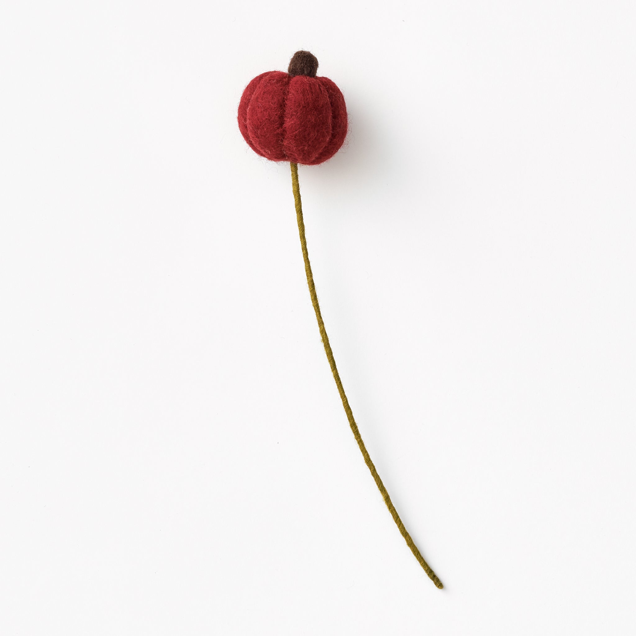 Red flower bud on a green stem against a white background, made by women artisans in Nepal | Global Goods Partners