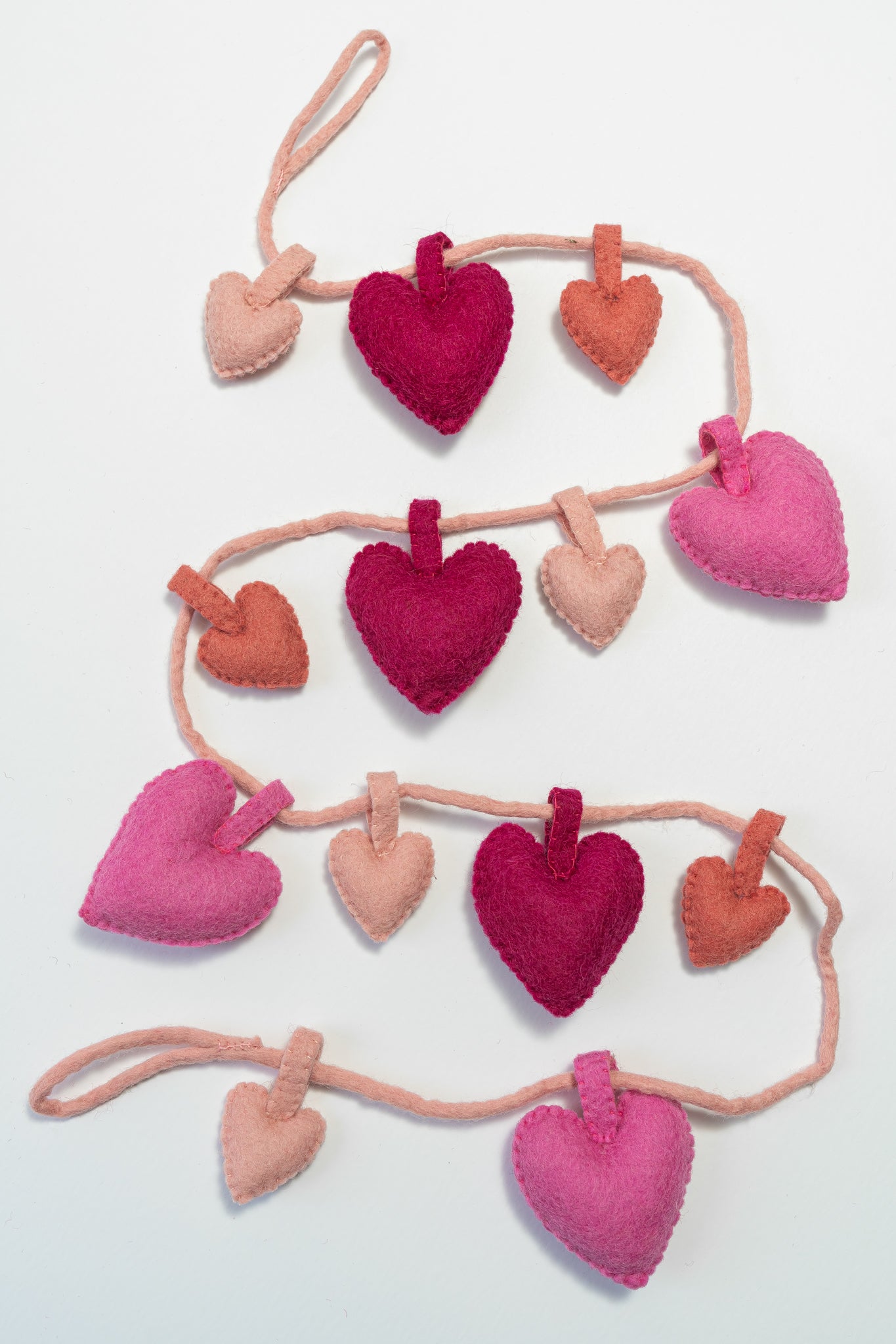 Felt handmade heart garland against a white background | Global Goods Partners