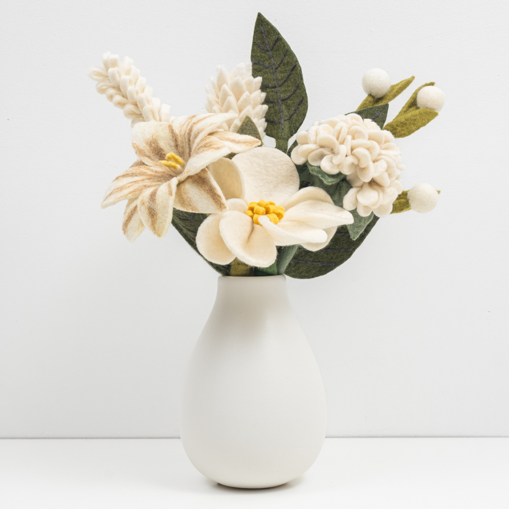 White vase with beautiful handcrafted felt flowers on a white background. Handmade, fair trade and ethical gifts | Global Goods Partners