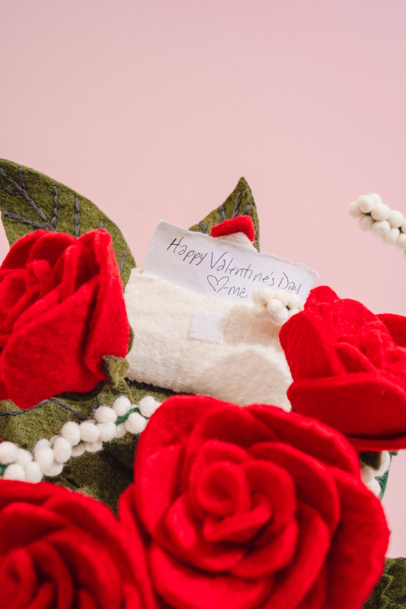 Valentine's Day card in a fair trade bouquet of red roses on a pink background | Global Goods Partners