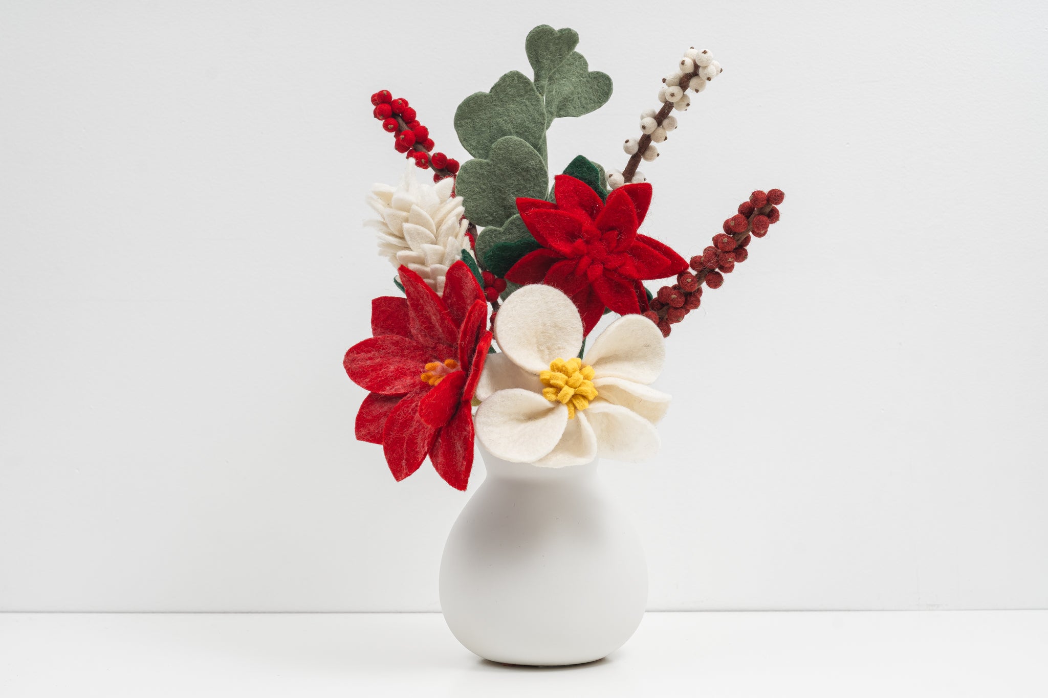 Decorative flower arrangement in a white vase on a light background. Handmade fair trade gift for loved ones | Global Goods Partners