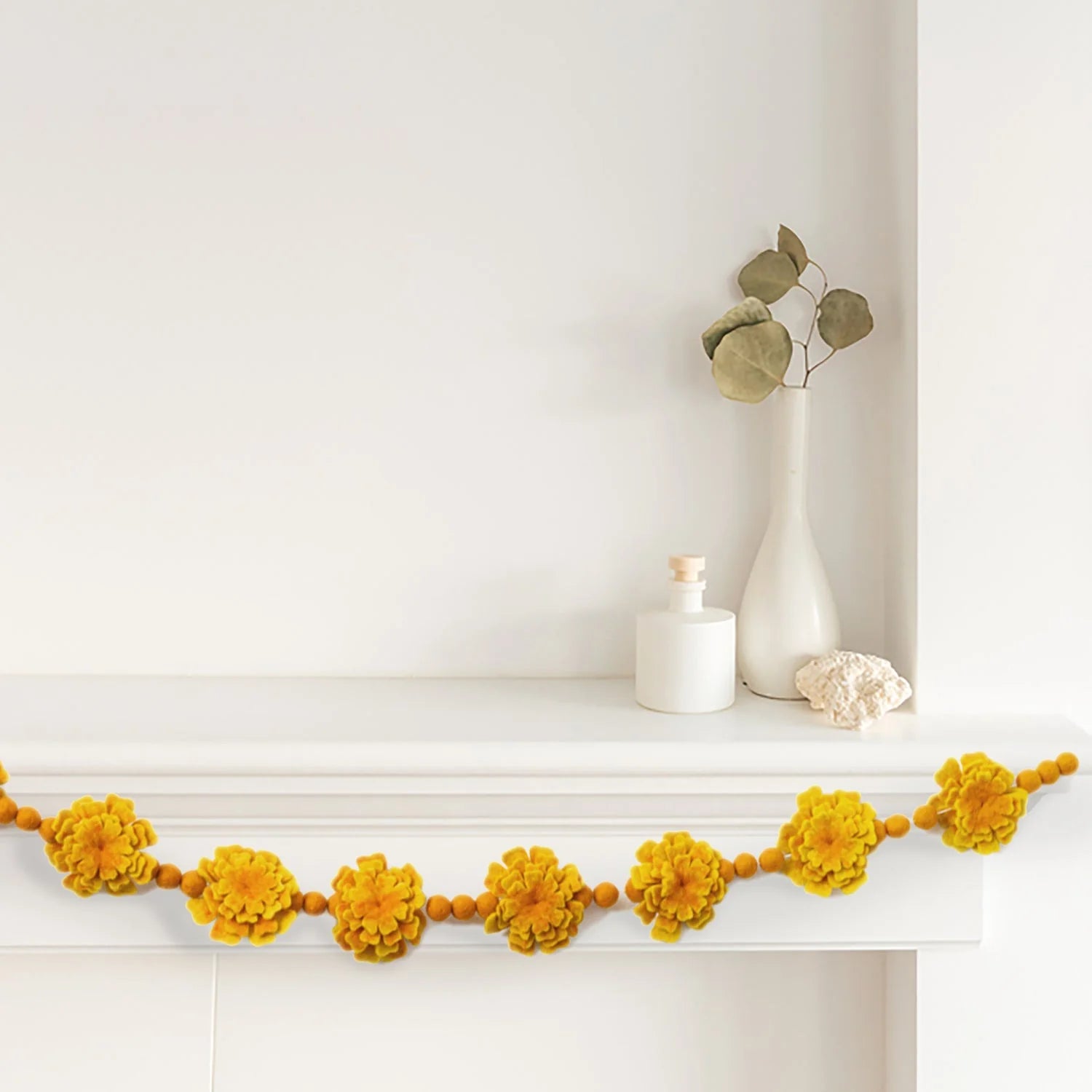 Orange Marigold Felt Flower Garland on Mantle decor _ Global Goods Partners Fair Trade