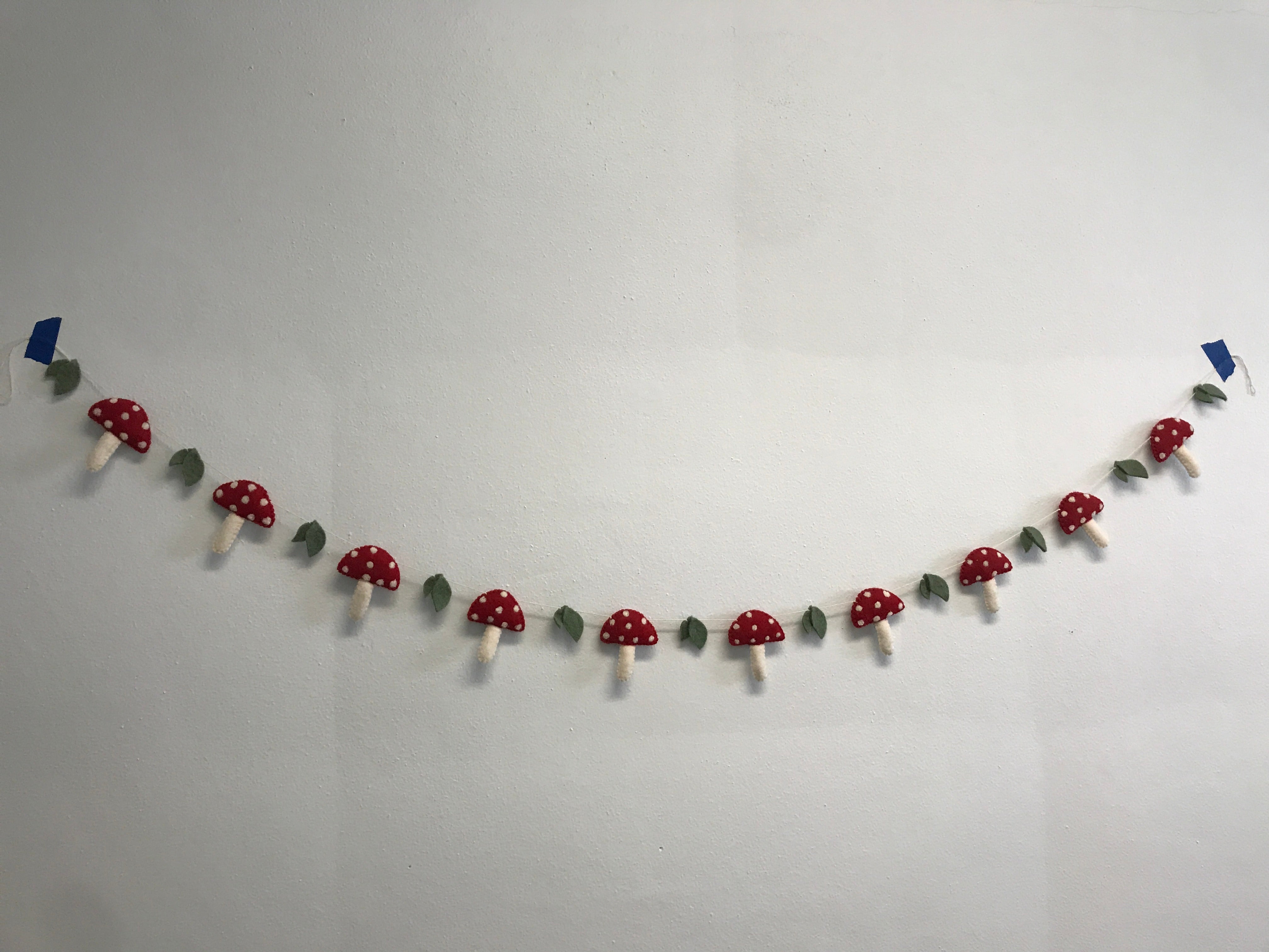 felt colorful mushroom decorative garland hanging on a wall - Global Goods Partners - Fair Trade