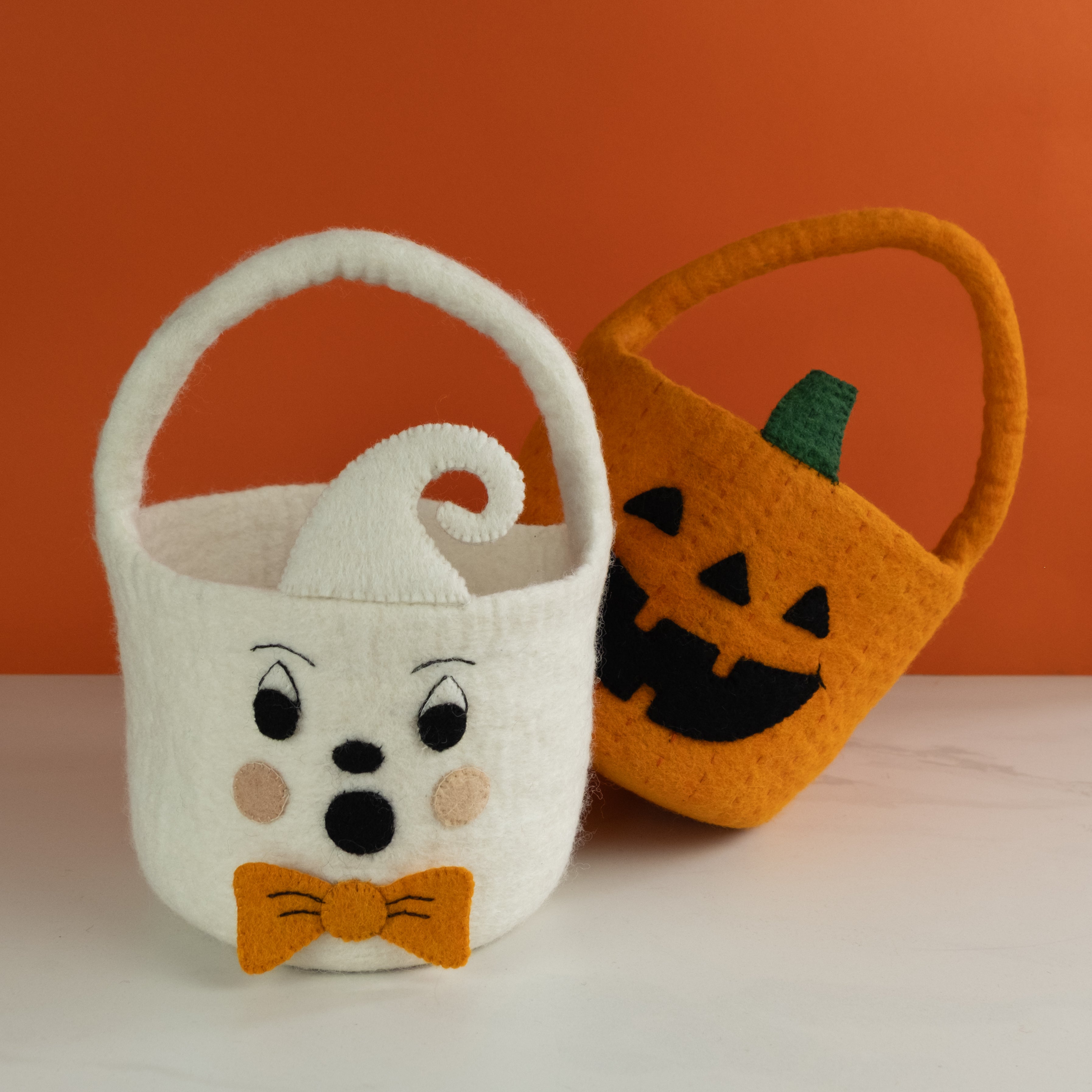 White ghost and orange pumpkin cute felt trick or treat halloween buckets with candy - fair trade- Global Goods Partners