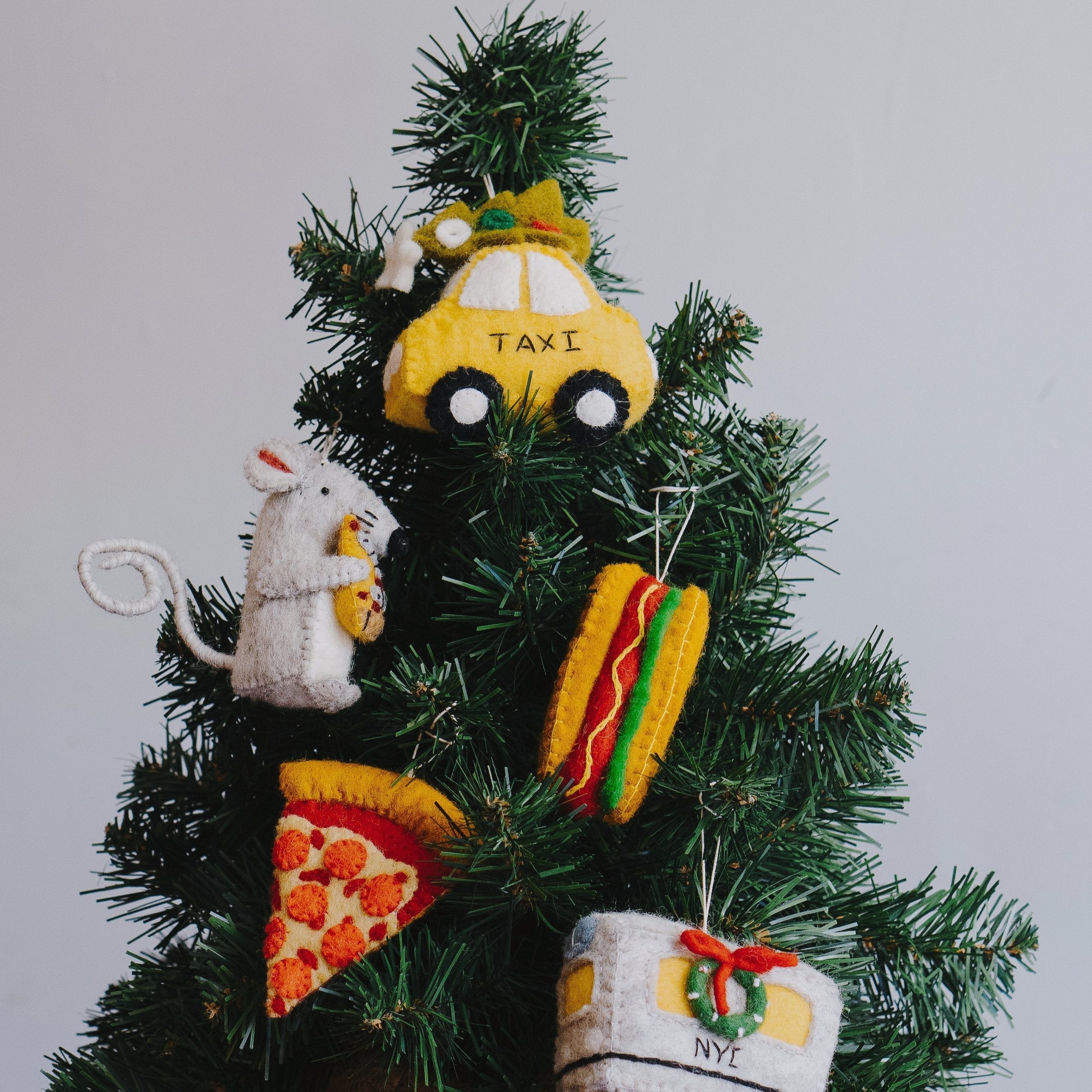 NYC Felt Ornament Series from Global Goods Partners hanging on a Christmas Tree
