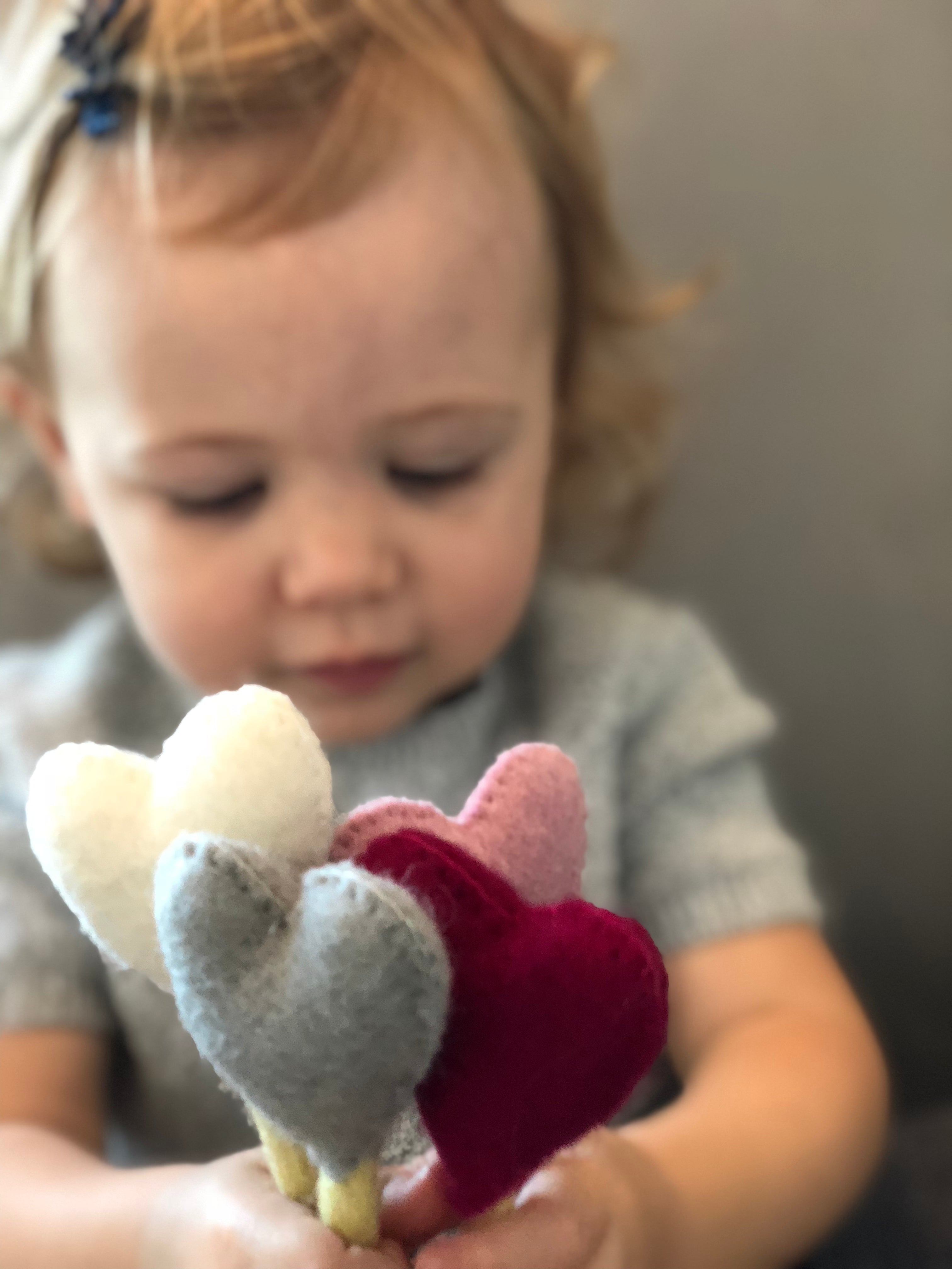 Felt Heart Stems in hands of child - Global Goods Partners