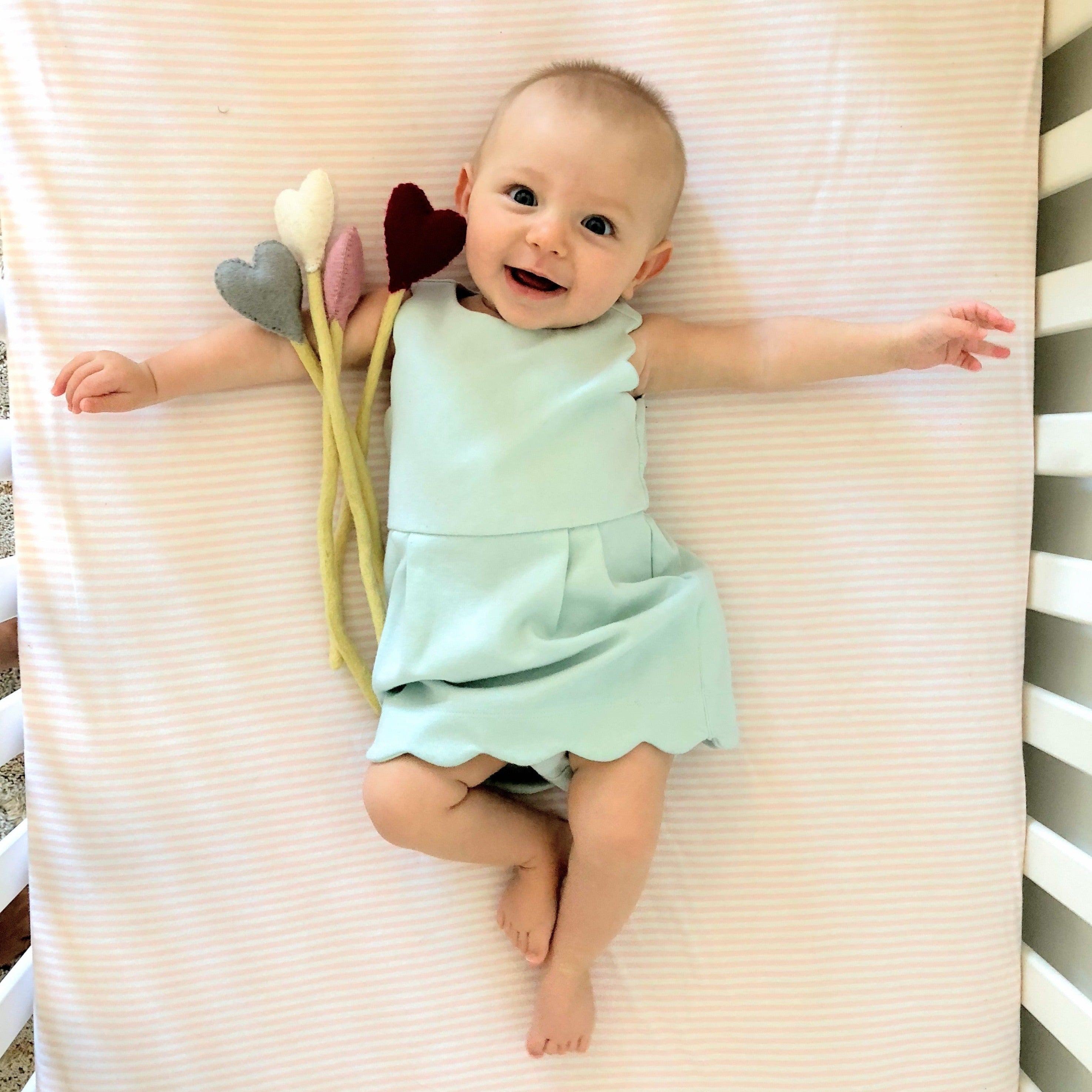 Felt Heart Stems in a crib photo with baby - Global Goods Partners