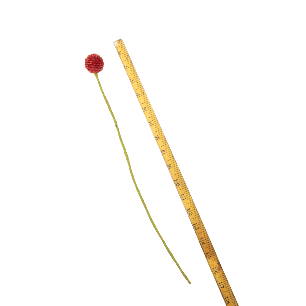 Long thin handmade craspedia with a red ball on top next to a ruler for scale on a white background | Global Goods Partners