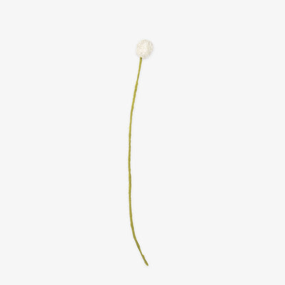 Single white handmade craspedia on a thin green stem against a white background | Global Goods Partners