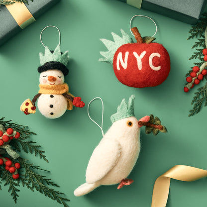 Decorative felt Christmas ornaments on a green background with 'NYC' text. Handmade by women artisans in Nepal.
