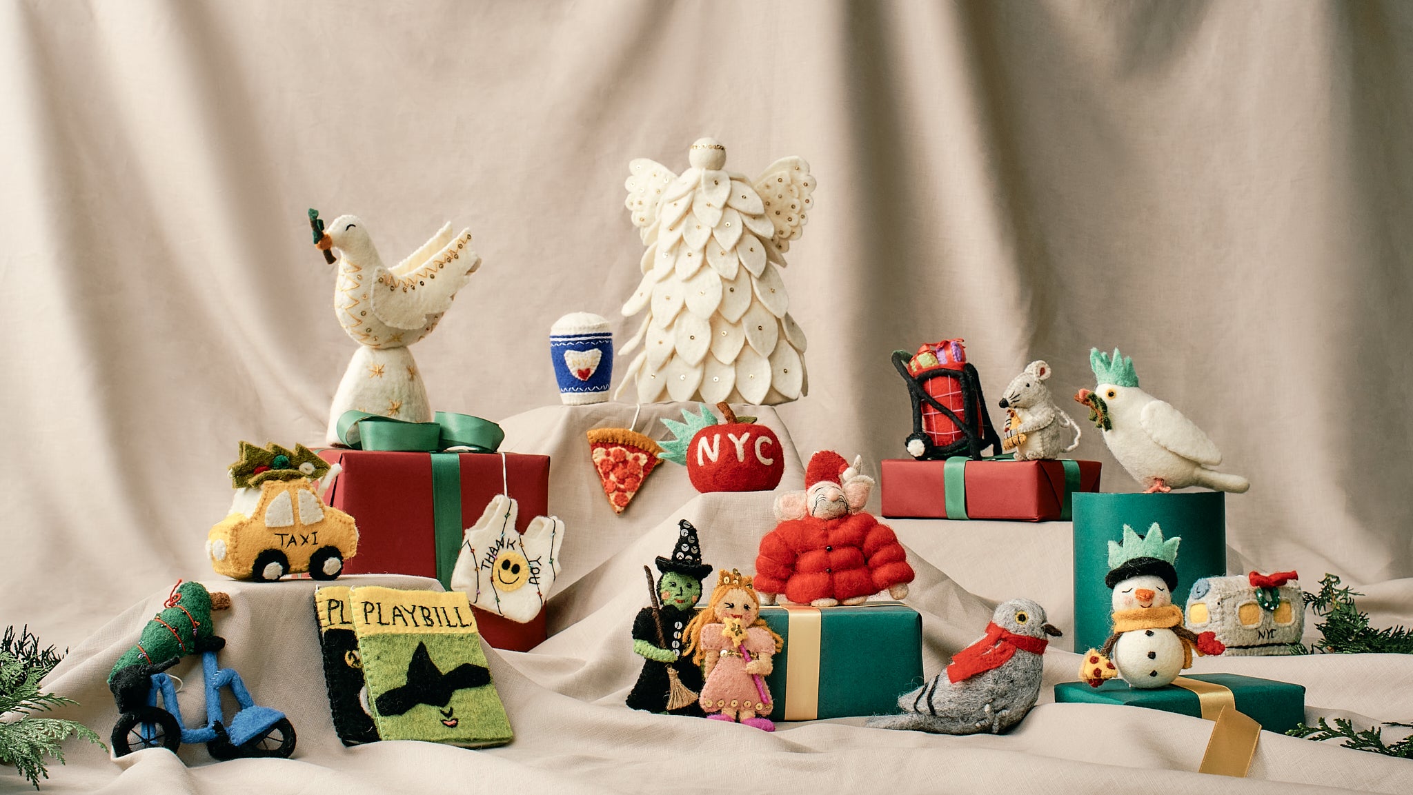 Collection of felted holiday ornament and decor on a neutral background, all handmade and fair trade.