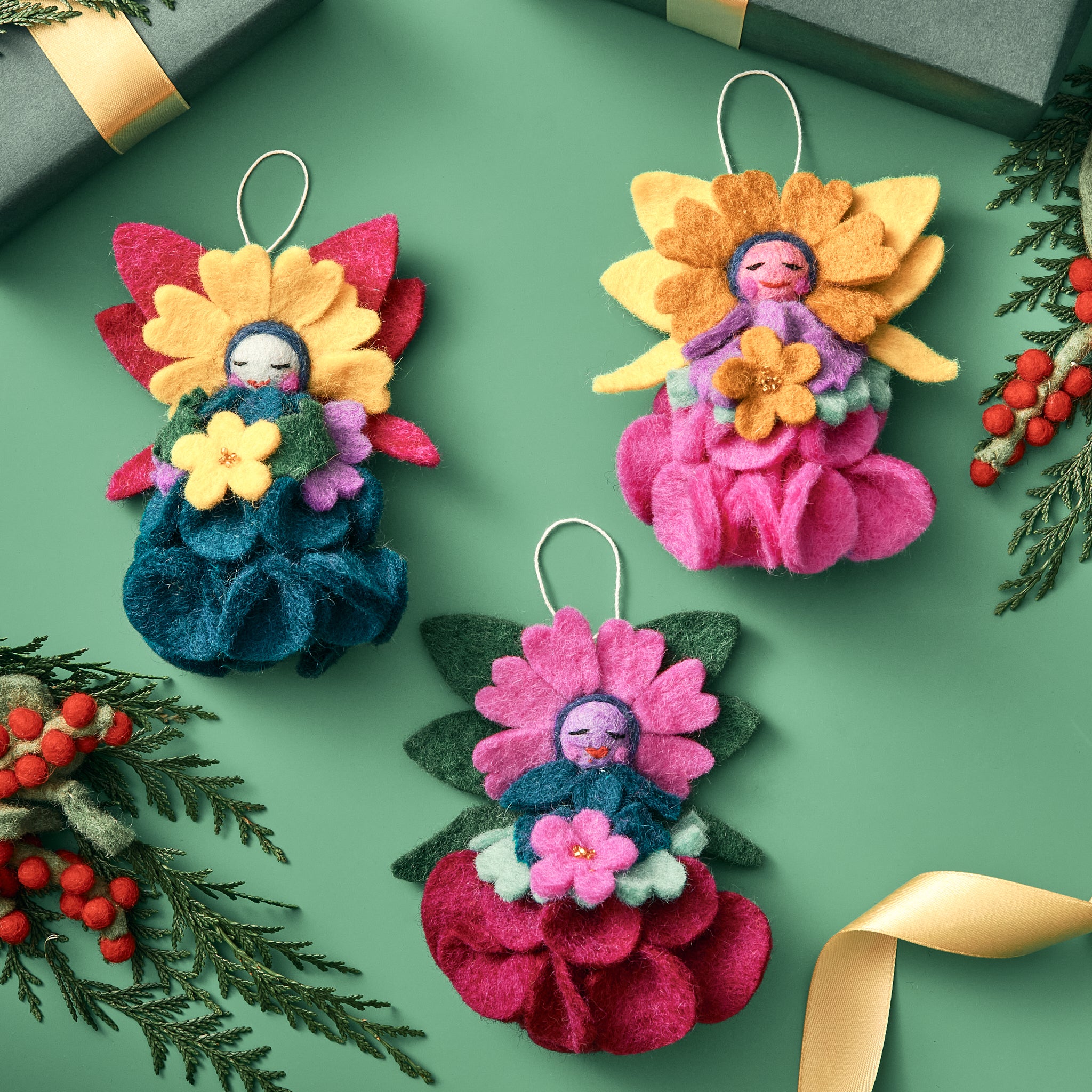 Handmade, fair trade felt ornaments with floral designs on a green background | Global Goods Partners