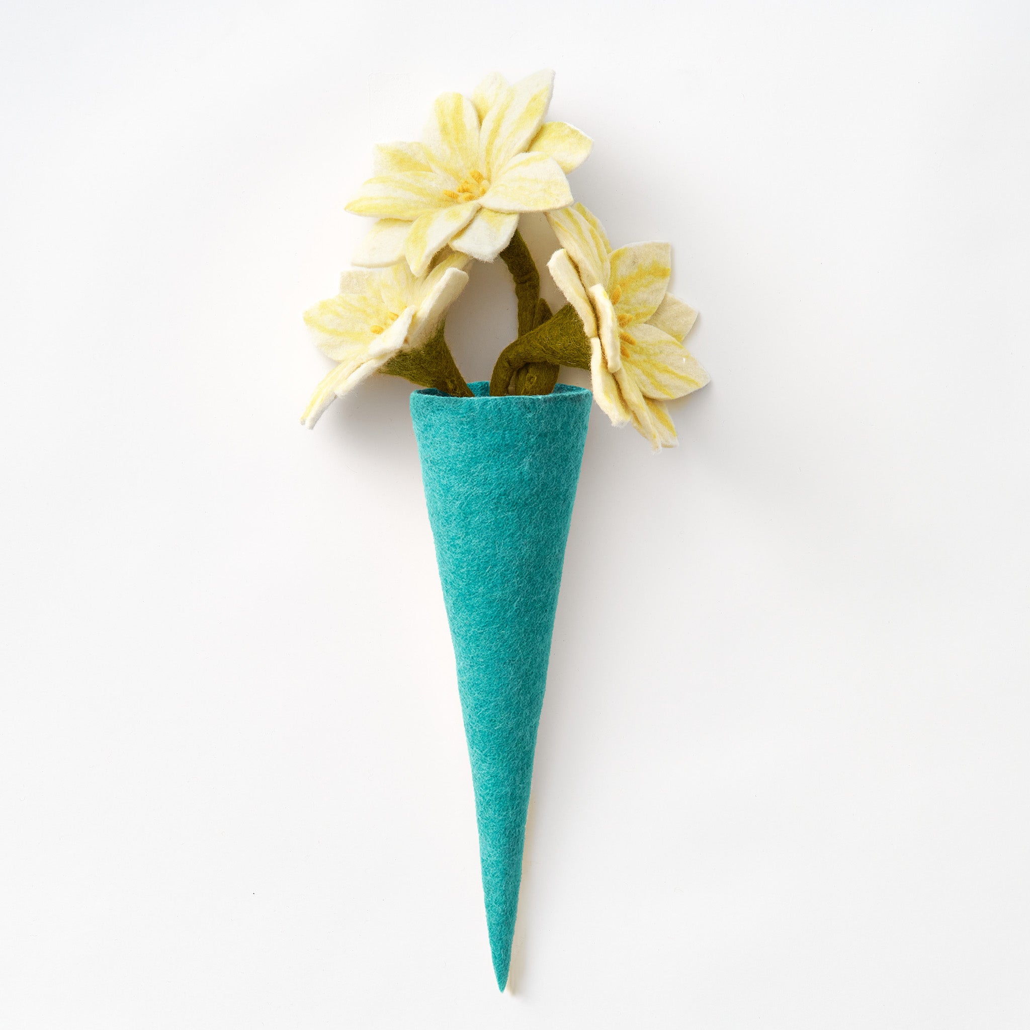 A teal felt vase with three pale yellow felt flowers with green stems, photographed against a clean white background. Handmade by women artisans in Nepal | Global Goods Partners