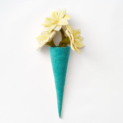 A teal felt vase with three pale yellow felt flowers with green stems, photographed against a clean white background. Handmade by women artisans in Nepal | Global Goods Partners