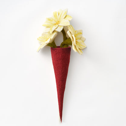 A handmade, fair trade felt vase in deep red, holding pale yellow felt flowers with green stems, photographed against a plain white background | Global Goods Partners