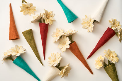 Colorful handmade felt vases with flowers on a white background, made by Nepali artisans | Global Goods Partners