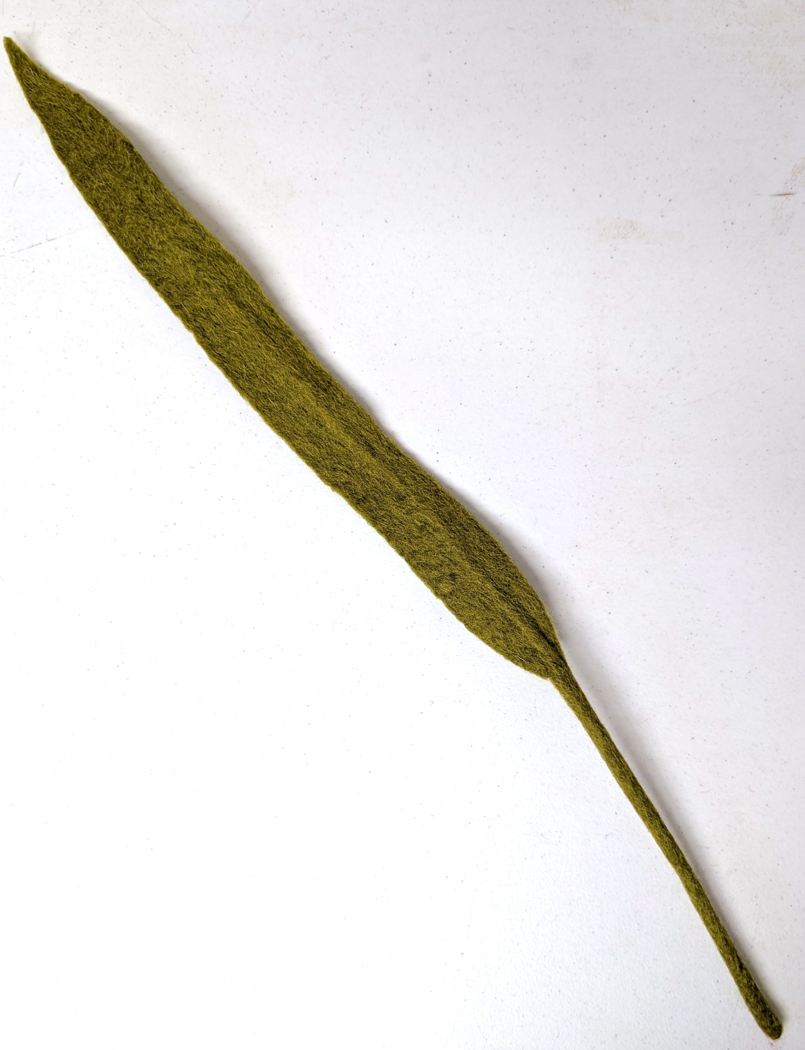 Long, narrow fair trade felt green leaf on a white background. Handmade by women artisans in Nepal | Global Goods Partners