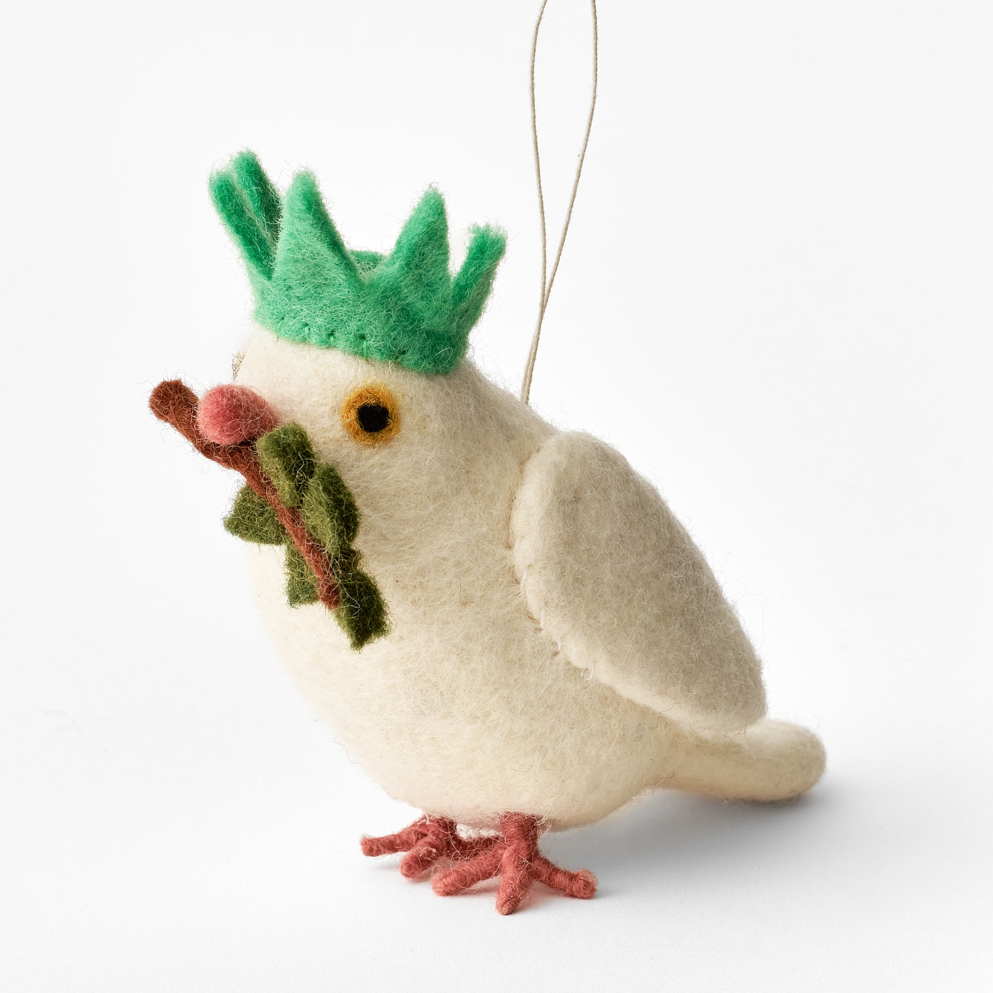 Handmade felt dove ornament with a green statue of liberty crown and olive branch on a white background. Fair trade. | Global Goods Partners