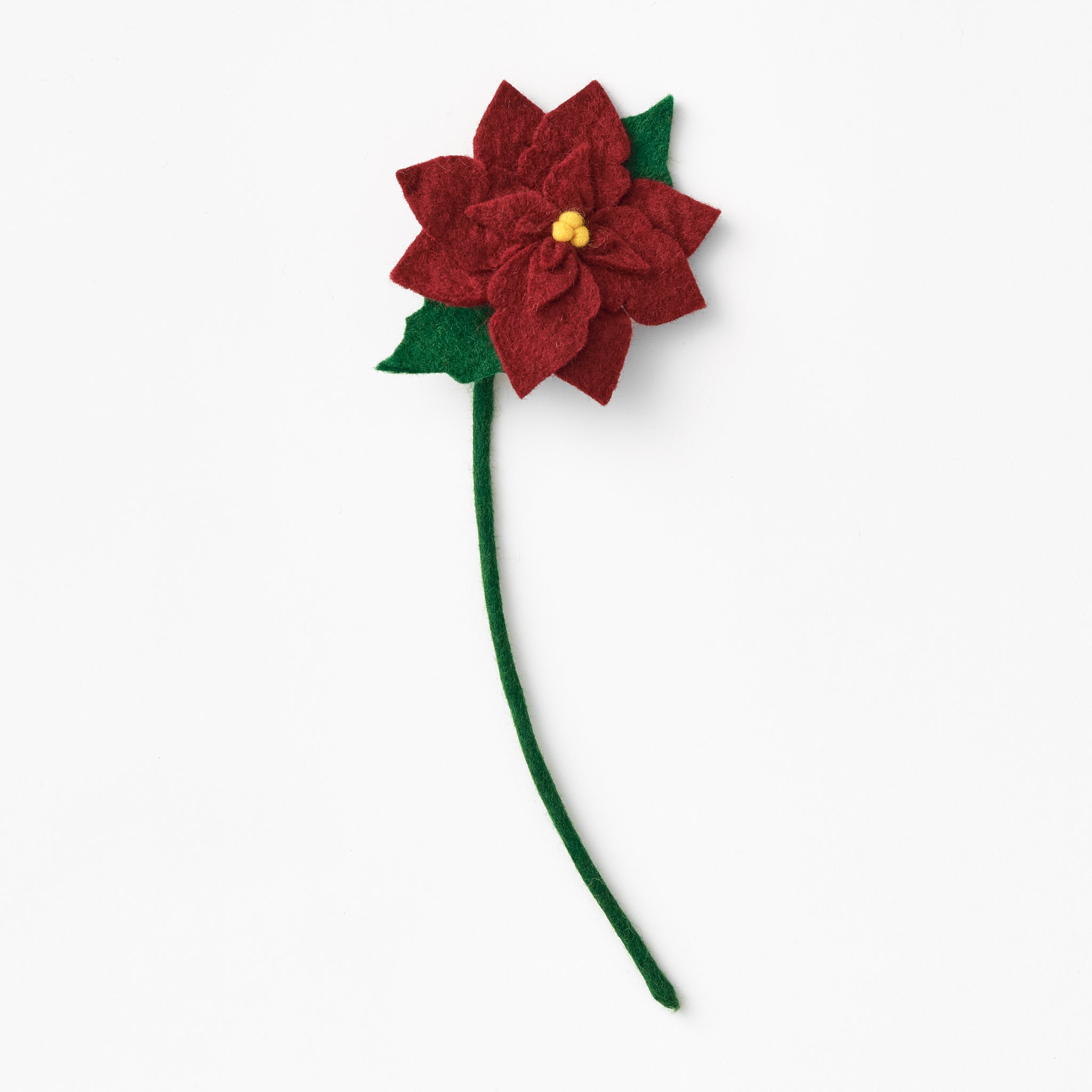 Red poinsettia flower with green stem on a white background. Fair trade & handmade | Global Goods Partners