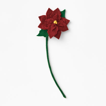 Red poinsettia flower with green stem on a white background. Fair trade & handmade | Global Goods Partners