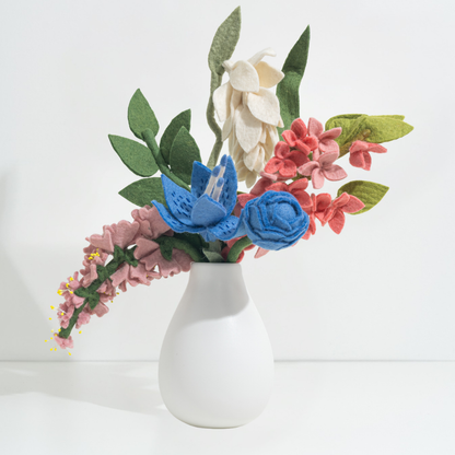 Felt flower arrangement in a white vase on a light background, flowers handmade by women artisans | Global Goods Partners