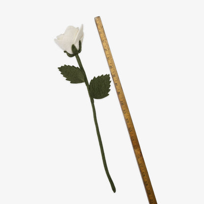 White felt rose with green stem and leaves next to a ruler on a white background, handmade by women artisans | Global Goods Partners