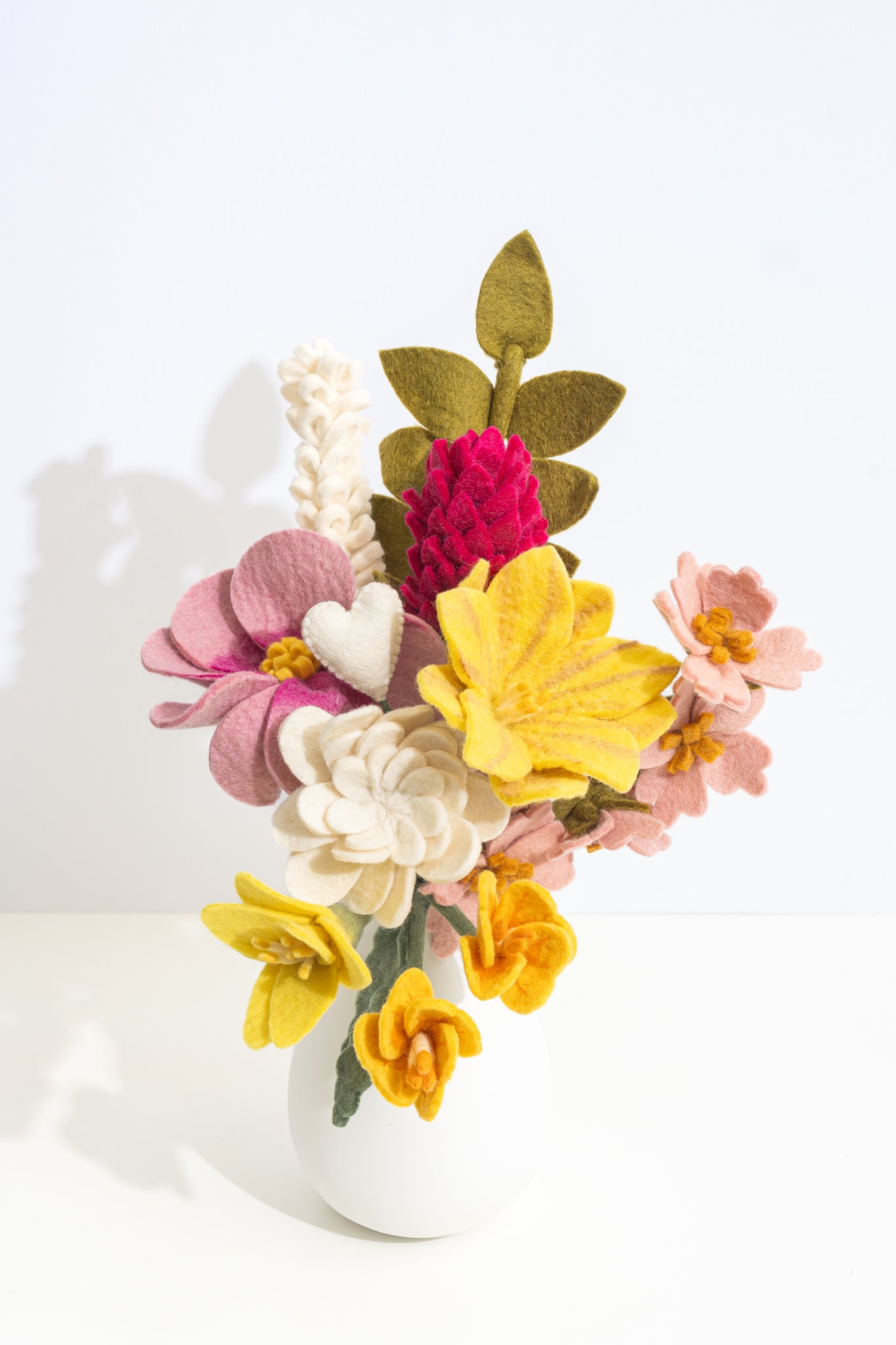 Colorful felt flower arrangement on a white background, flowers are fair trade and made by women artisans in Nepal | Global Goods Partners