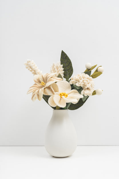 White vase with a bouquet of crisp white felt flowers on a white background. Handmade in Nepal by artisans earning a fair wage | Global Goods Partners