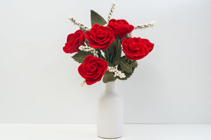 Handmade felt red roses in a white vase on a light gray background, fair trade | Global Goods Partners