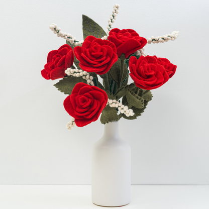 Bouquet of handmade red felt roses in a white vase on a light gray background | Global Goods Partners