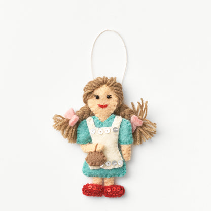 Handmade, fair trade, felt ornament of Dorothy with brown hair, wearing a blue dress and red sparky shoes, on a white background | Global Goods Partners