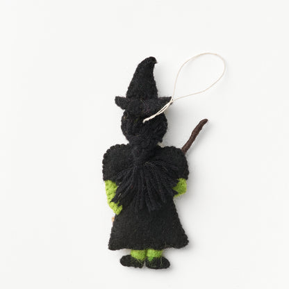 Black and green knitted witch ornament on a white background with braided hair | Global Goods Partners