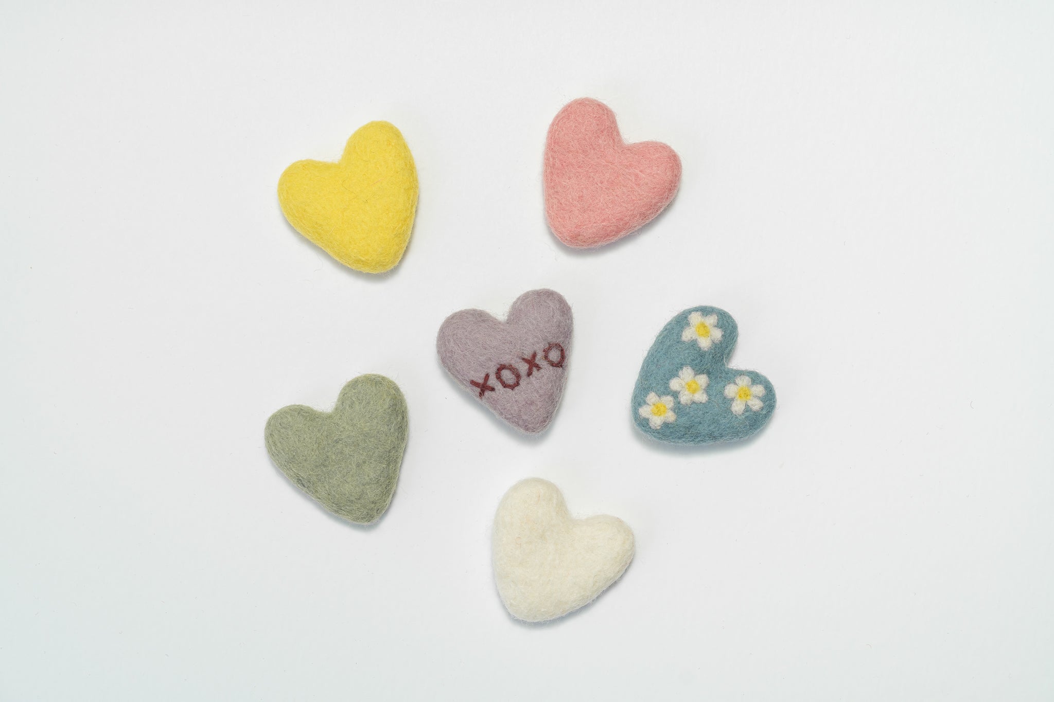 Set of fair trade colorful heart-shaped kids toys on a light gray background | Global Goods Partners